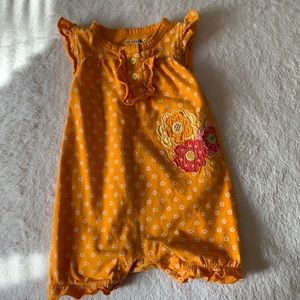 A baby orange floral jam suite for 3-6 months old girls